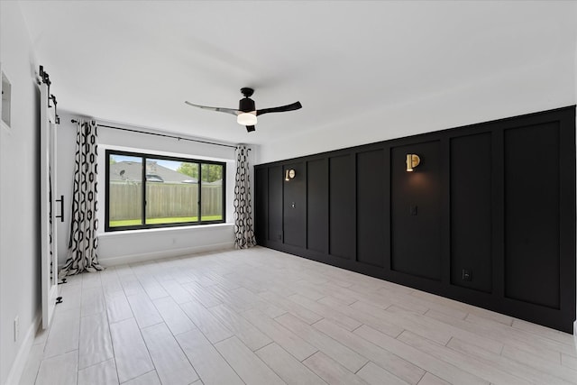 2611 Teague Rd, Houston, TX 77080 - interior space featuring a barn door and a ceiling fan
