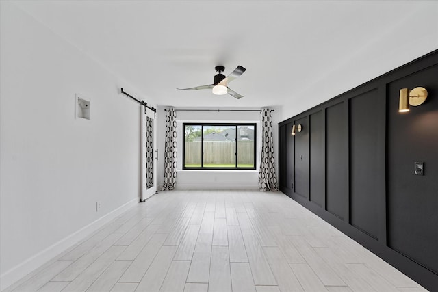 2611 Teague Rd, Houston, TX 77080 - unfurnished room with ceiling fan, a barn door, and baseboards