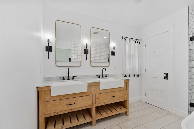 2611 Teague Rd, Houston, TX 77080 - full bath with baseboards, tile patterned flooring, double vanity, and a sink