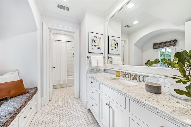 bathroom with vanity, ornamental molding, shower / bath combo, and visible vents