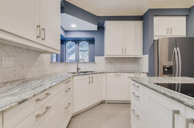 714 Last Arrow Dr, Houston, TX 77079 - kitchen with stainless steel fridge, a sink, white cabinetry, light tile patterned floors, and ornamental molding