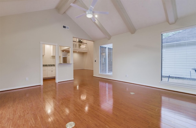 714 Last Arrow Dr, Houston, TX 77079 - unfurnished living room with beam ceiling, light wood-style flooring, a ceiling fan, high vaulted ceiling, and a chandelier