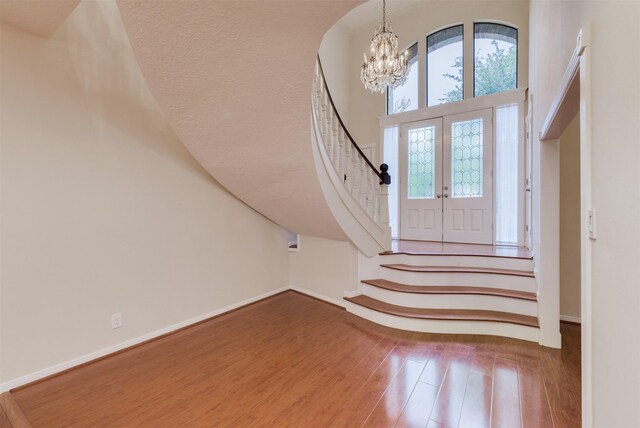 714 Last Arrow Dr, Houston, TX 77079 - entrance foyer with a chandelier, stairs, wood finished floors, baseboards, and a towering ceiling