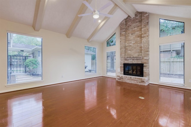 714 Last Arrow Dr, Houston, TX 77079 - unfurnished living room featuring wood finished floors, beam ceiling, a brick fireplace, high vaulted ceiling, and ceiling fan