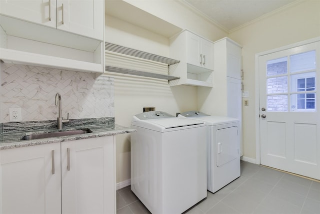 714 Last Arrow Dr, Houston, TX 77079 - clothes washing area with independent washer and dryer, ornamental molding, cabinet space, light tile patterned flooring, and baseboards