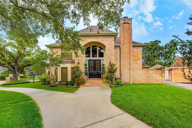 714 Last Arrow Dr, Houston, TX 77079 - traditional home featuring french doors, a chimney, brick siding, a front lawn, and cooling unit