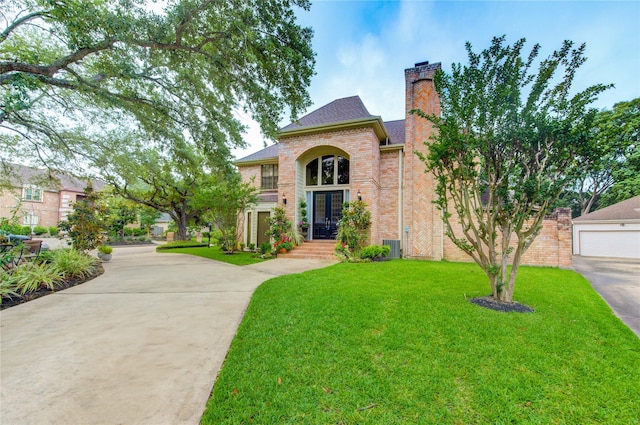 714 Last Arrow Dr, Houston, TX 77079 - traditional-style home with brick siding, a front yard, a chimney, roof with shingles, and concrete driveway