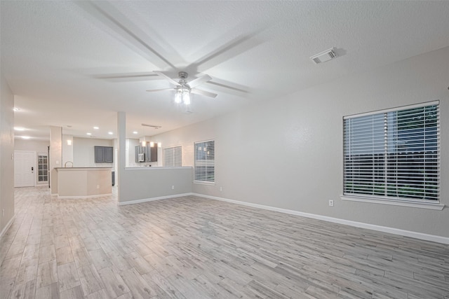 unfurnished living room featuring a ceiling fan, baseboards, recessed lighting, light wood-type flooring, and visible vents