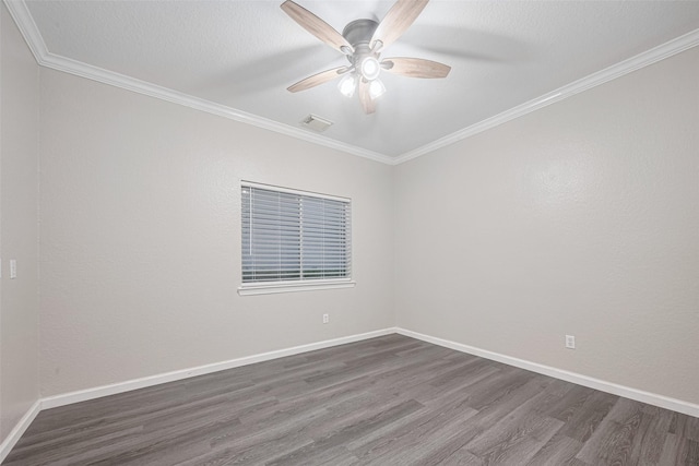 unfurnished room with ceiling fan, visible vents, crown molding, baseboards, and dark wood-type flooring