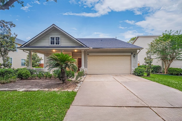view of front facade with a porch, a front yard, concrete driveway, an attached garage, and a shingled roof