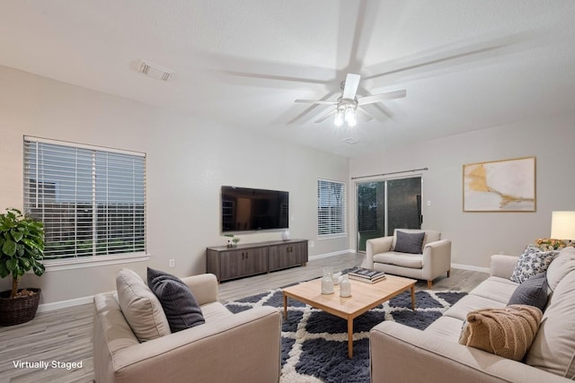 living room featuring baseboards, ceiling fan, wood finished floors, and visible vents