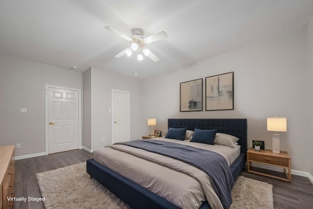 bedroom with baseboards, ceiling fan, and dark wood-style flooring