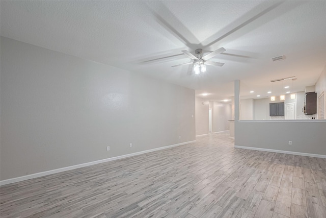 interior space featuring ceiling fan, visible vents, light wood-type flooring, baseboards, and recessed lighting