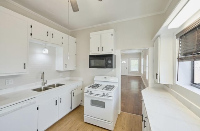 219 W 13th St, Houston, TX 77008 - kitchen with a ceiling fan, white cabinetry, a sink, white appliances, and light wood-style flooring