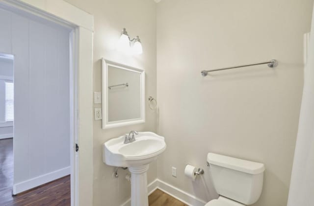 219 W 13th St, Houston, TX 77008 - half bathroom featuring toilet, baseboards, a sink, and wood finished floors