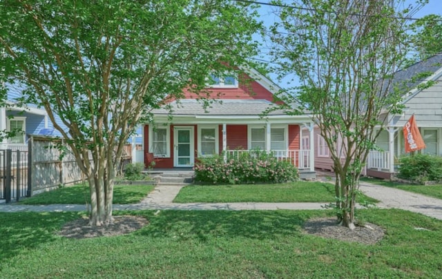219 W 13th St, Houston, TX 77008 - view of front of house with fence, covered porch, and a front lawn