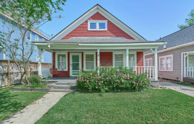 219 W 13th St, Houston, TX 77008 - view of front of property with roof with shingles, covered porch, and a front yard