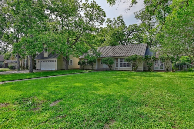 708 4th St, Sealy, TX 77474 - view of front facade featuring french doors, metal roof, and a front lawn