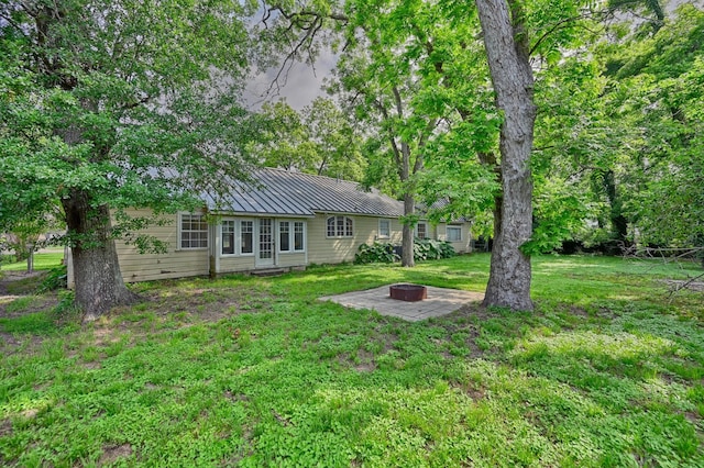 708 4th St, Sealy, TX 77474 - view of green lawn with a fire pit