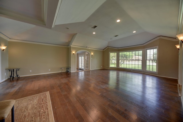 708 4th St, Sealy, TX 77474 - unfurnished living room featuring lofted ceiling, hardwood / wood-style floors, arched walkways, baseboards, and recessed lighting