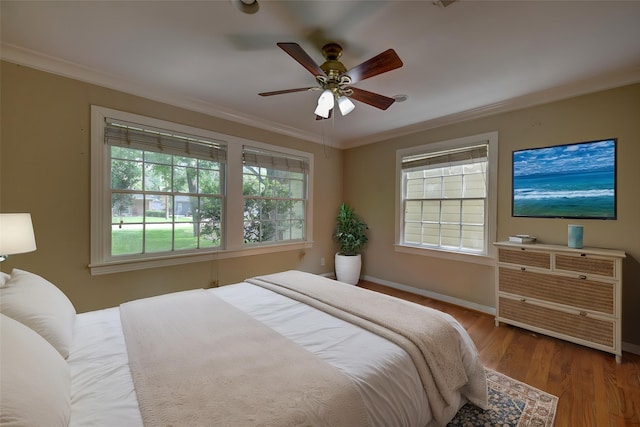 708 4th St, Sealy, TX 77474 - bedroom with crown molding, wood finished floors, baseboards, and ceiling fan
