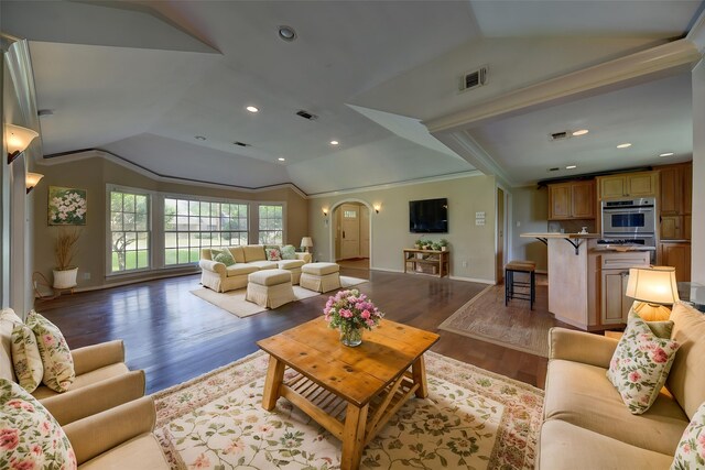 708 4th St, Sealy, TX 77474 - living area featuring lofted ceiling, wood finished floors, arched walkways, baseboards, and ornamental molding