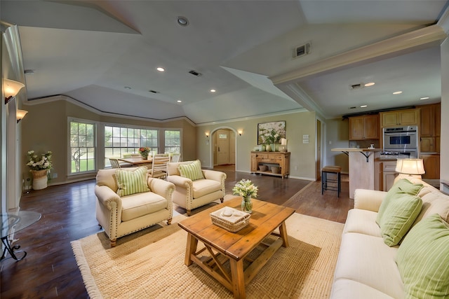 708 4th St, Sealy, TX 77474 - living room with lofted ceiling, wood finished floors, arched walkways, baseboards, and recessed lighting