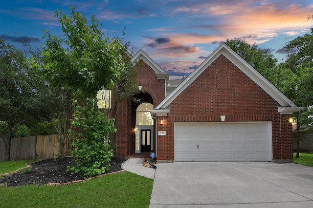 13730 Anderson Woods Dr, Houston, TX 77070 - traditional-style house featuring concrete driveway, an attached garage, fence, and brick siding