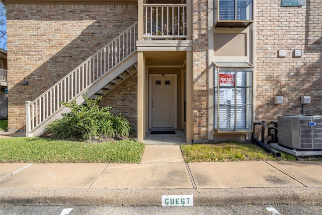 1311 Antoine Dr Unit 245, Houston, TX 77055 - doorway to property with brick siding, central AC, and a balcony