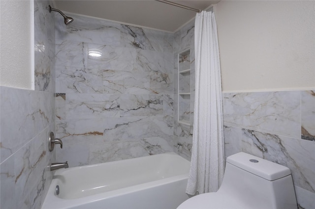 1311 Antoine Dr Unit 245, Houston, TX 77055 - full bathroom featuring toilet, tile walls, wainscoting, and shower / bath combo