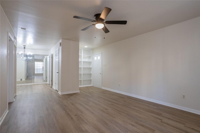 1311 Antoine Dr Unit 245, Houston, TX 77055 - spare room featuring baseboards, ceiling fan with notable chandelier, and wood finished floors