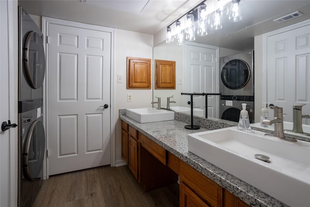 1311 Antoine Dr Unit 245, Houston, TX 77055 - full bathroom with a sink, wood finished floors, stacked washer / dryer, and visible vents