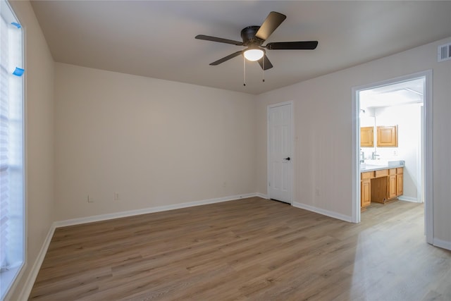 1311 Antoine Dr Unit 245, Houston, TX 77055 - unfurnished bedroom featuring light wood-style floors, baseboards, ensuite bathroom, and visible vents