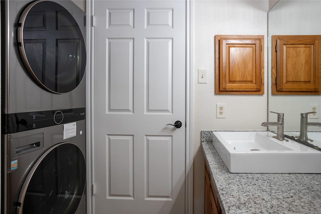 1311 Antoine Dr Unit 245, Houston, TX 77055 - washroom with laundry area, a sink, and stacked washer / dryer