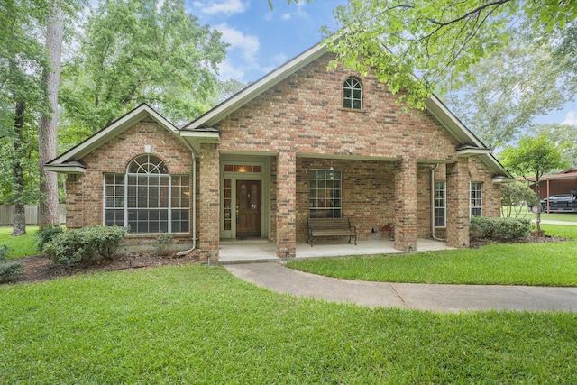 ranch-style home with brick siding and a front yard