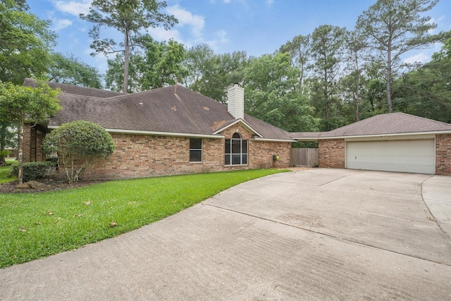 single story home featuring concrete driveway, brick siding, a front yard, and a garage