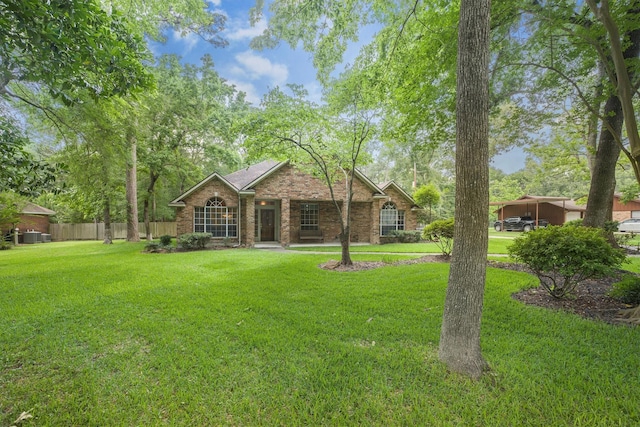 back of property featuring fence, a yard, and brick siding