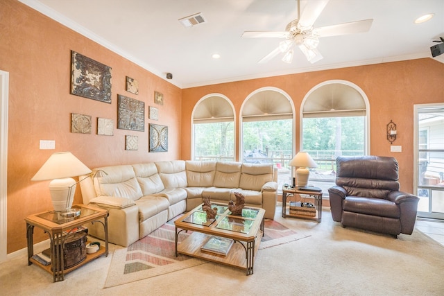 living room featuring crown molding, ceiling fan, visible vents, and carpet
