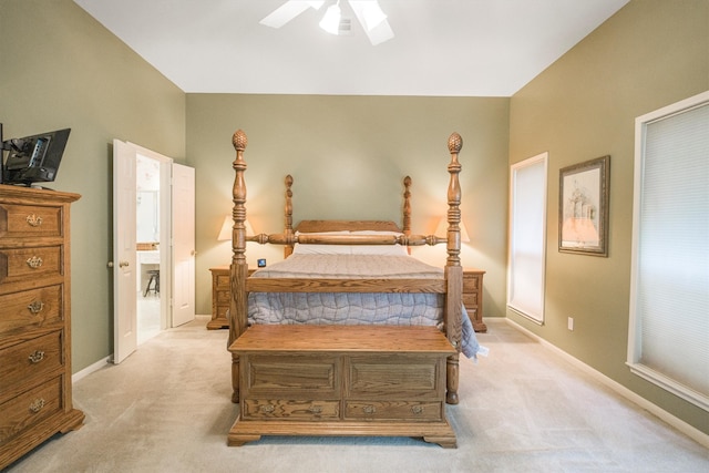 bedroom with ceiling fan, light carpet, and baseboards