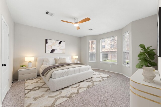 bedroom featuring baseboards, a ceiling fan, carpet flooring, and visible vents