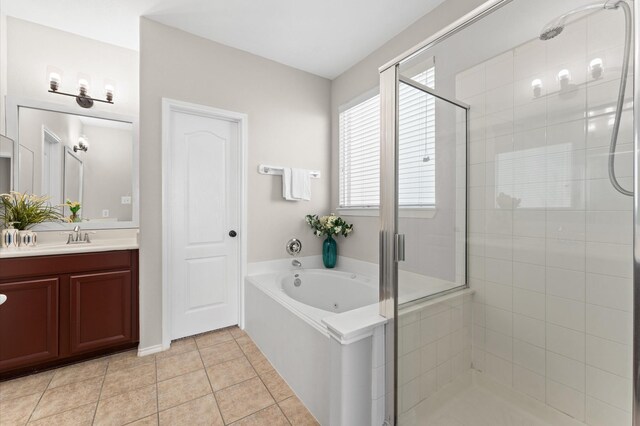 full bath featuring vanity, a shower stall, tile patterned floors, and a garden tub