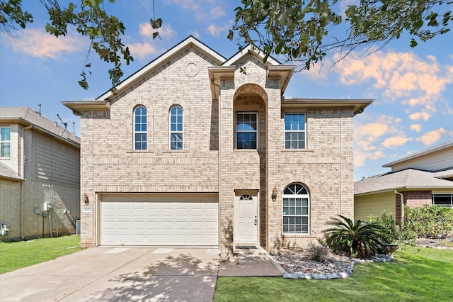 traditional home with brick siding, an attached garage, driveway, and a front yard