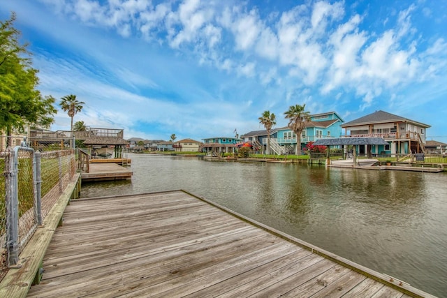 dock area with a residential view and a water view