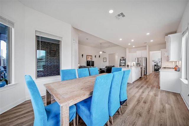 dining space featuring visible vents, baseboards, recessed lighting, a ceiling fan, and light wood-style flooring