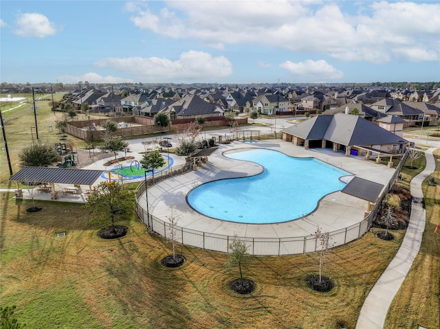 pool with a residential view and fence