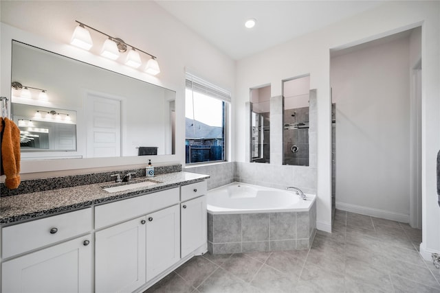 full bath featuring a garden tub, vanity, baseboards, tile patterned floors, and a tile shower