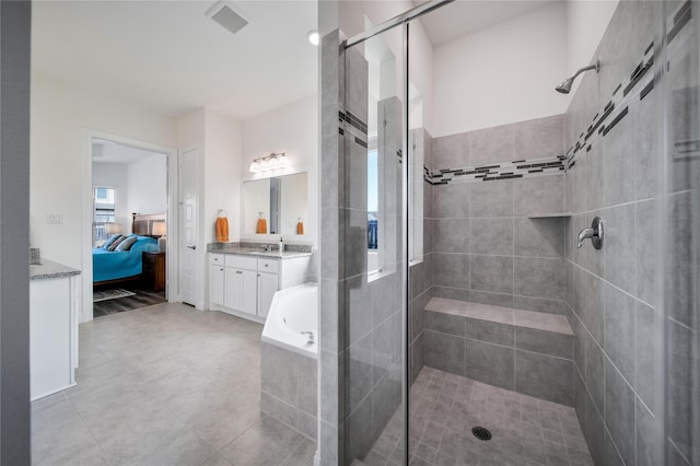 full bathroom featuring connected bathroom, visible vents, a shower stall, and vanity
