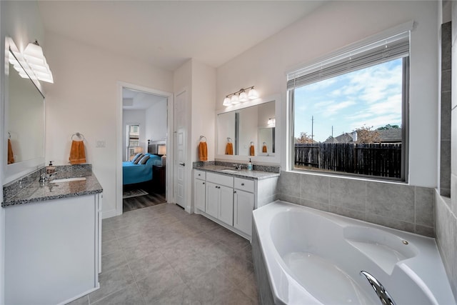 full bathroom with connected bathroom, a sink, tile patterned flooring, two vanities, and a garden tub