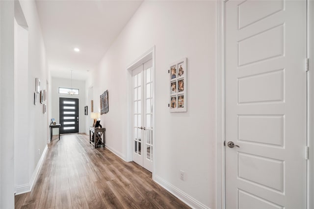 hall with baseboards, french doors, recessed lighting, and wood finished floors