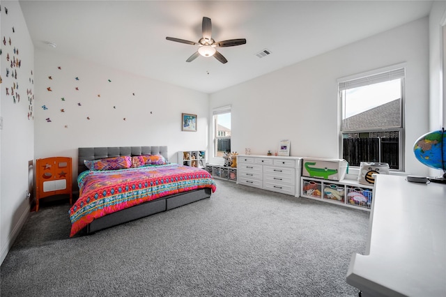 carpeted bedroom with a ceiling fan and visible vents